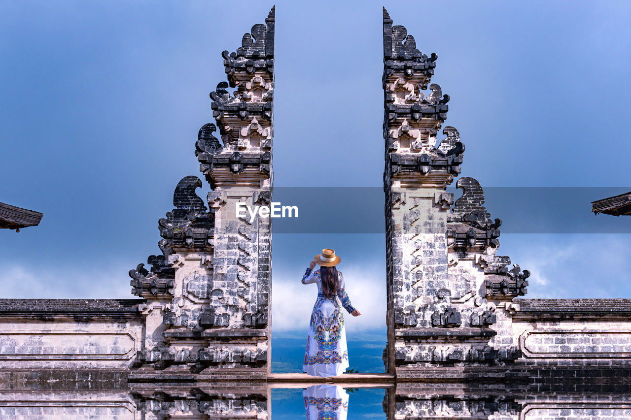 Asian woman standing in bali gate, pura luhur lempuyang temple bali, indonesia