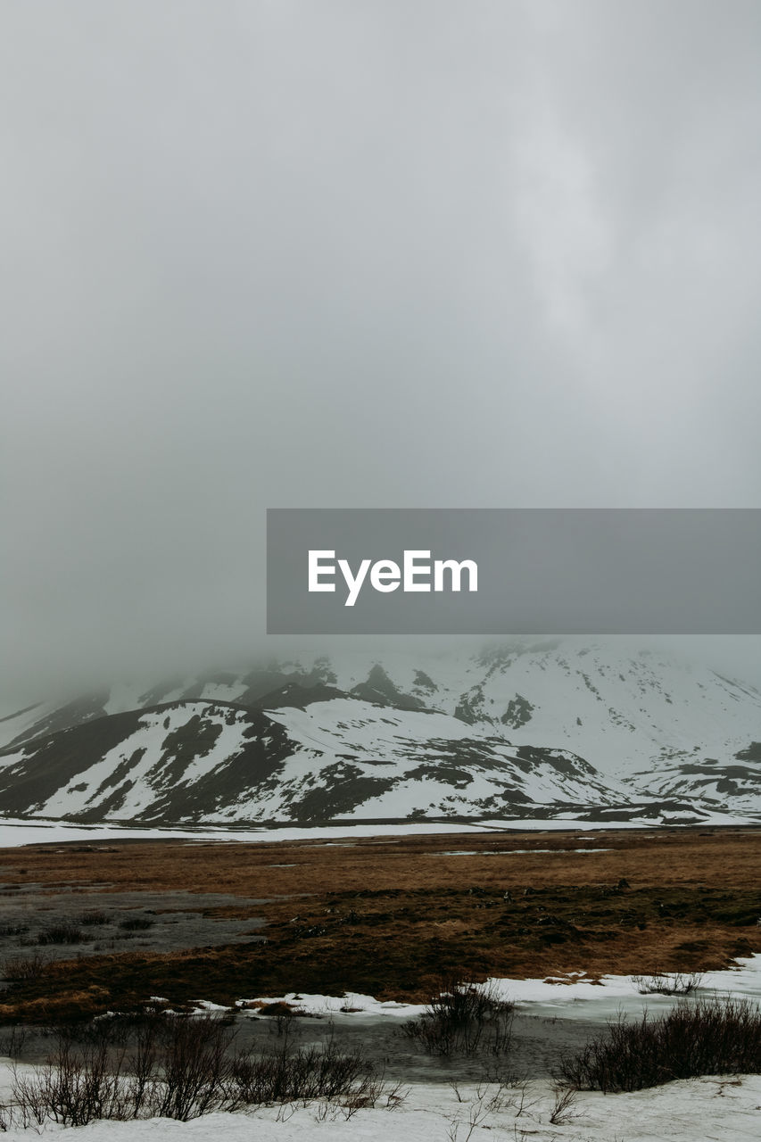 Scenic view of snowcapped mountains against sky during winter