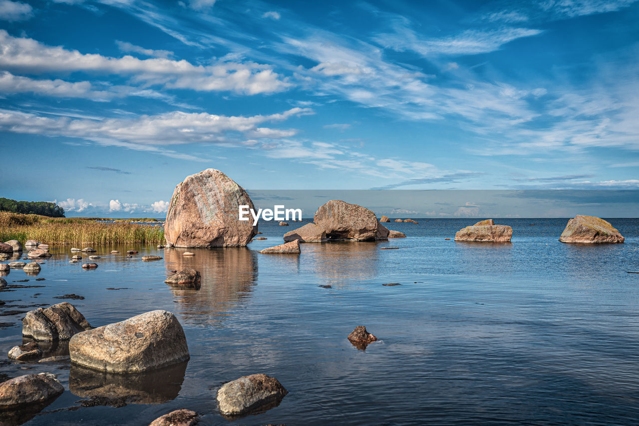 Rocks in sea against sky