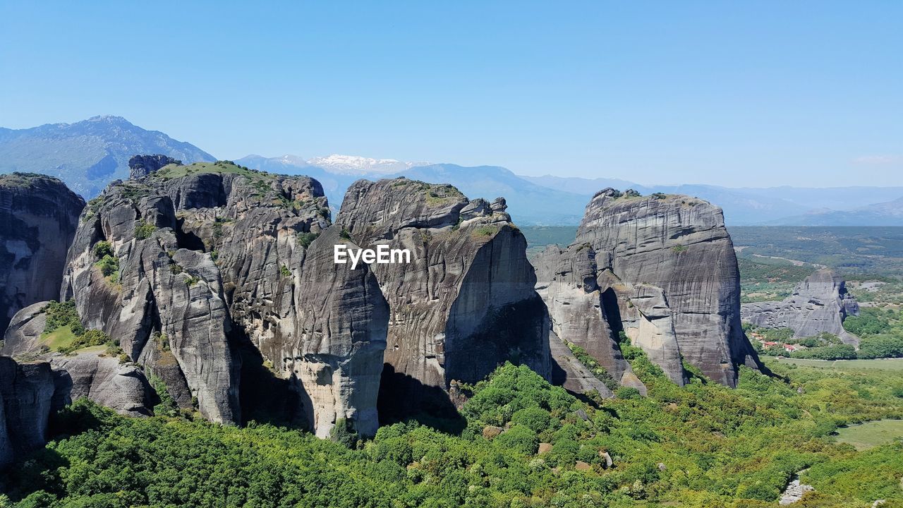 Panoramic shot of meteora rocks on landscape against sky