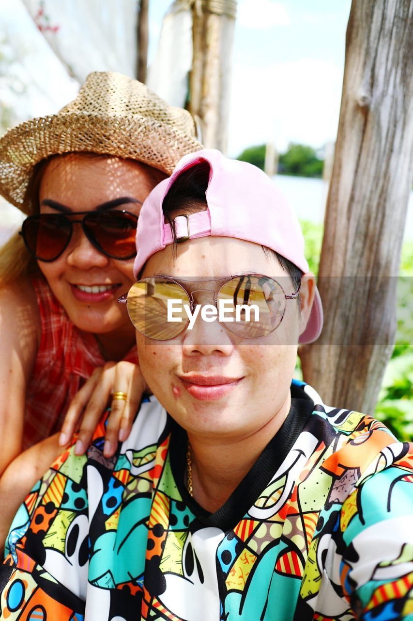 Portrait of smiling women wearing sunglasses