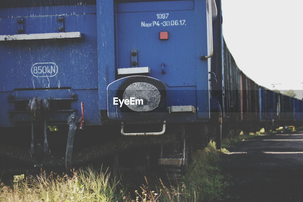 VIEW OF OLD TRAIN AGAINST BLUE SKY