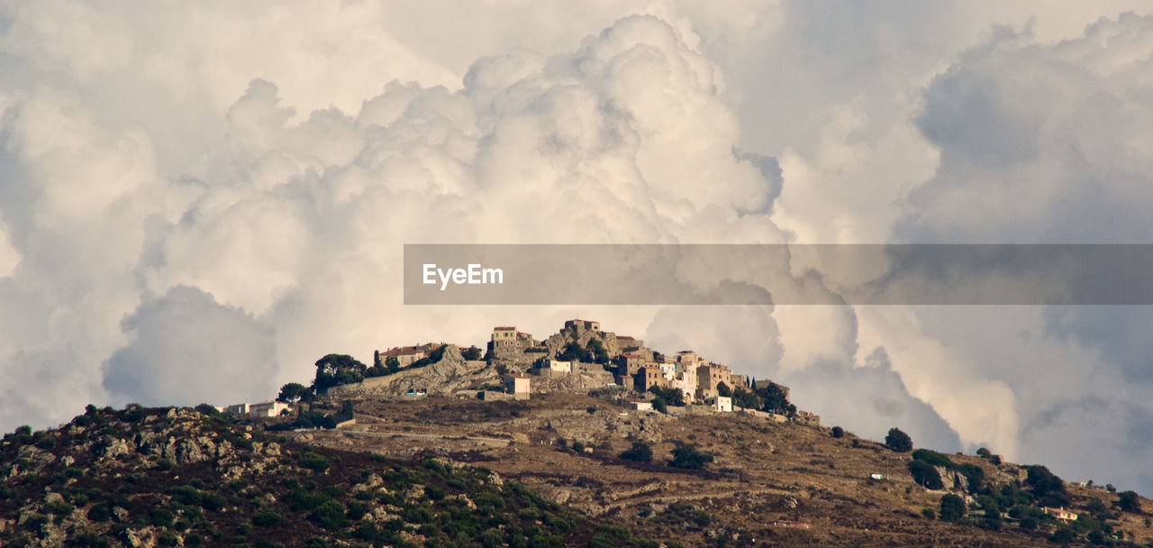 Panoramic view of rocks on land against sky