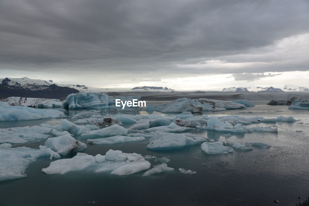 FROZEN LAKE AGAINST SKY