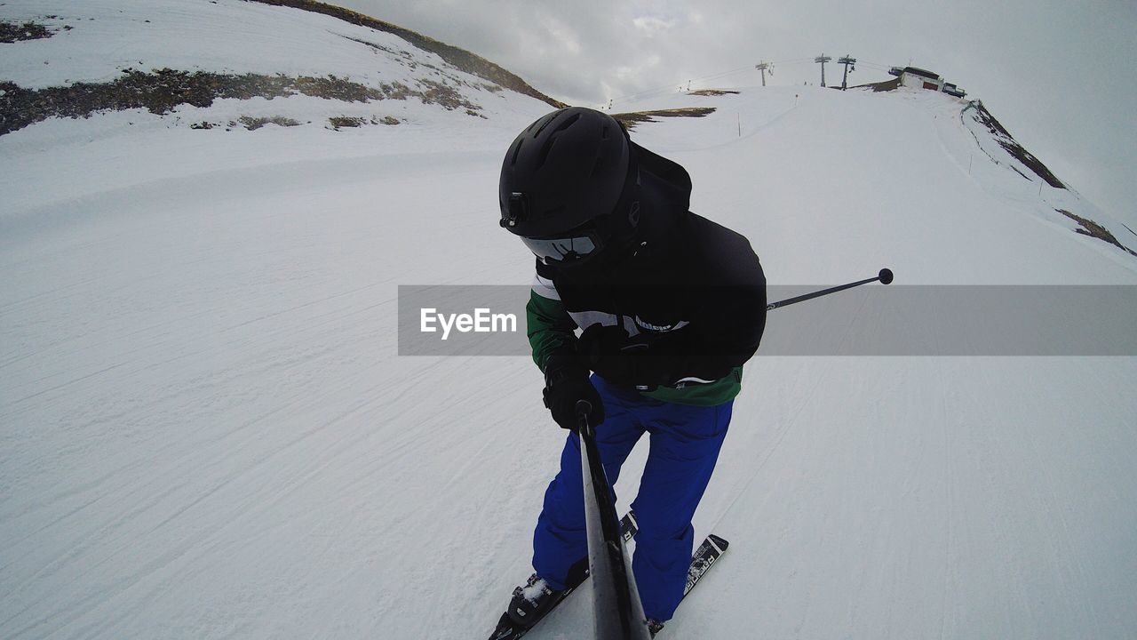 MAN IN SNOW ON LANDSCAPE