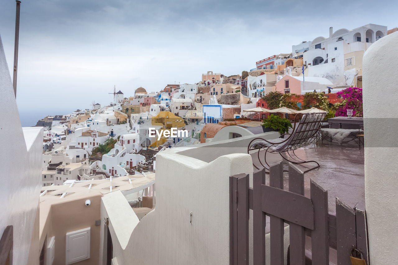 View of colorful houses of oia on a rare rainy day, santorini, greece