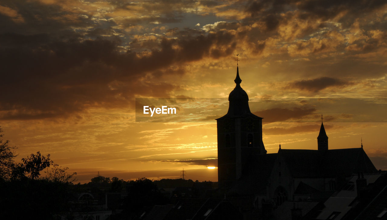 Silhouette of a church seen from the rooftop of the opposite building. summer dusk