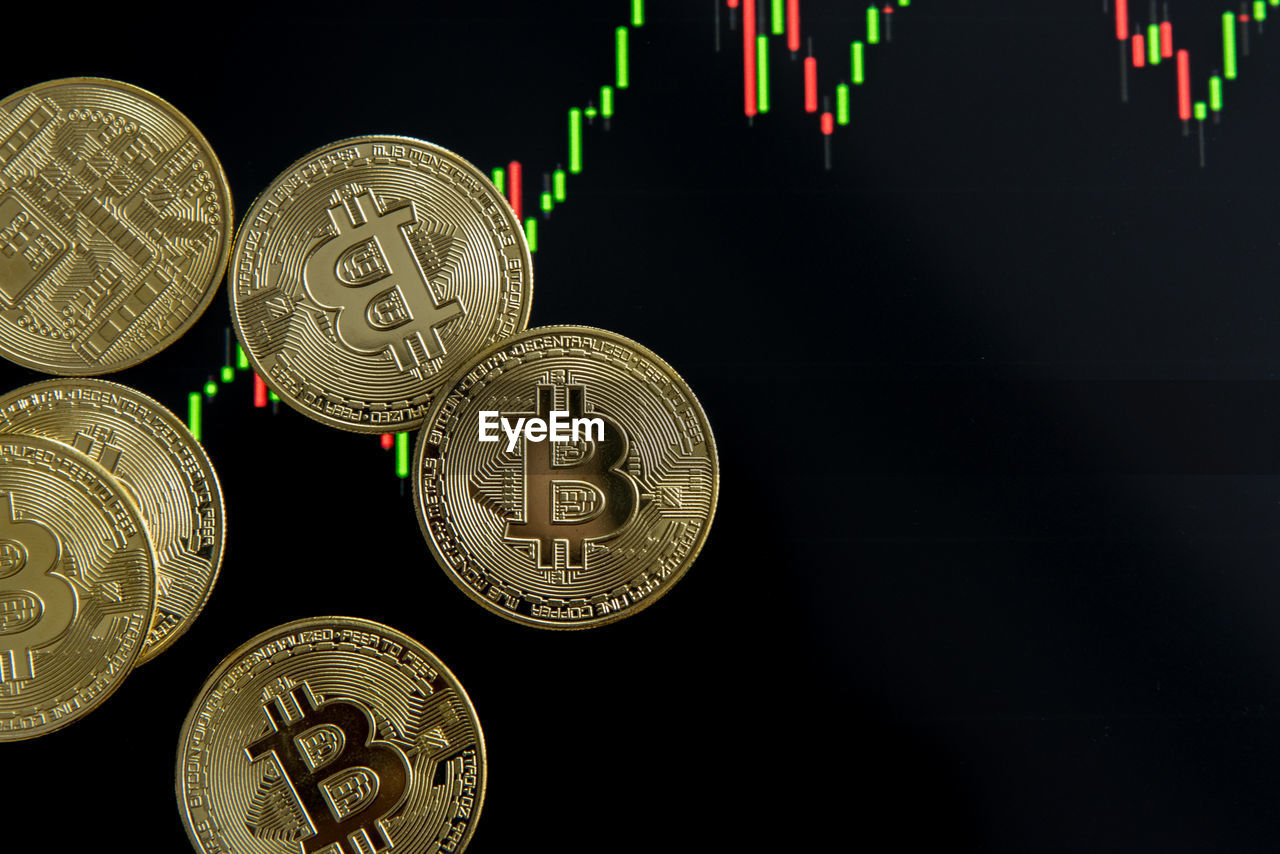 CLOSE-UP OF COINS IN BLACK BACKGROUND