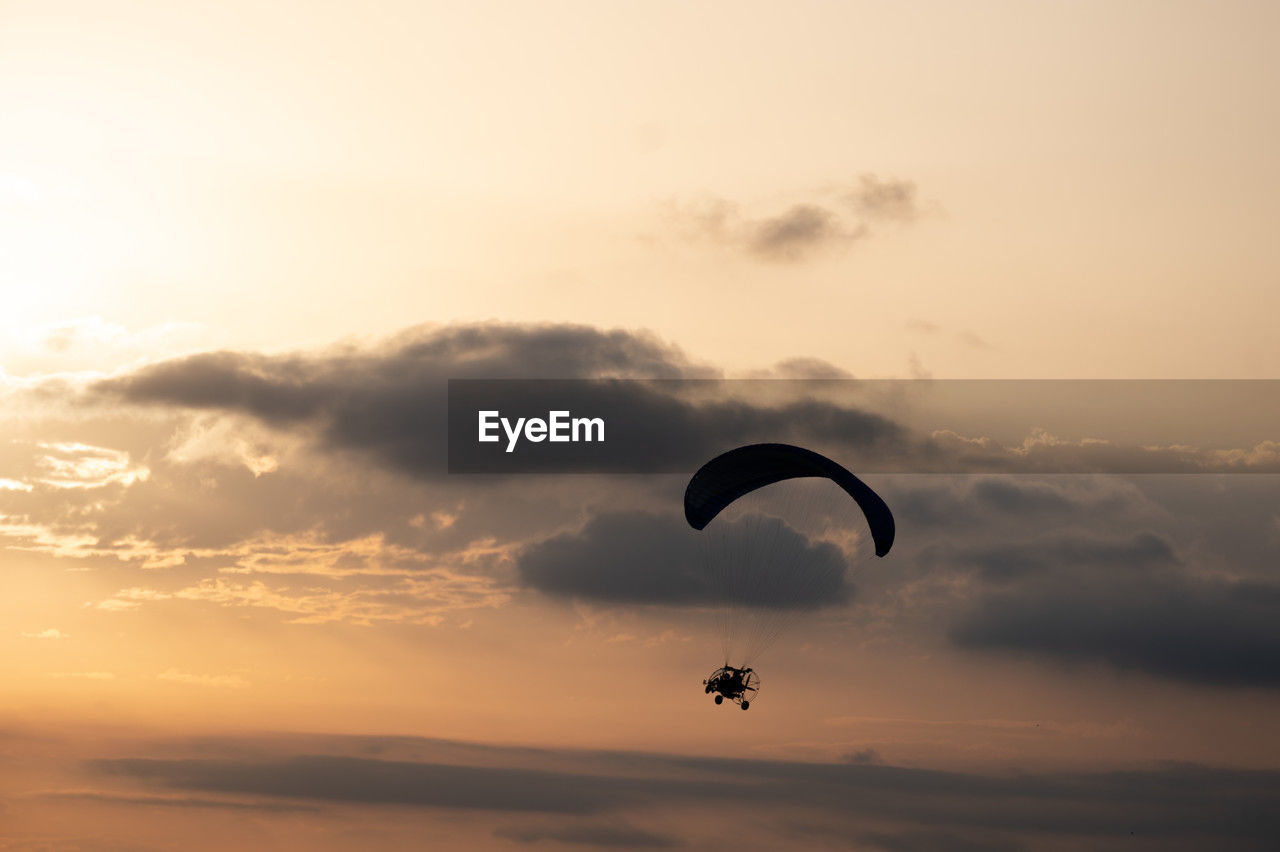 Paramotor silhouette with dramatic background skies