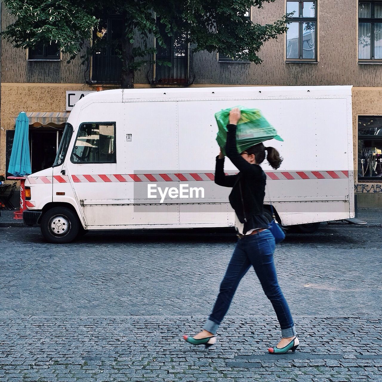 Woman carrying scrap by van