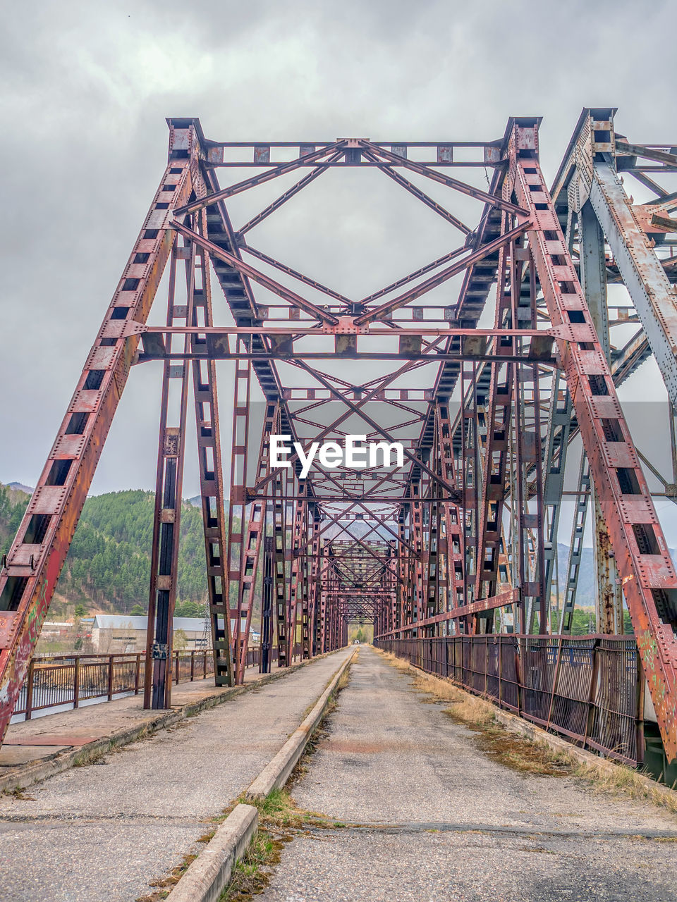 bridge, architecture, transportation, built structure, sky, cloud, nature, metal, travel destinations, no people, outdoors, road, city, the way forward, day, transport, water, travel, industry, park, amusement ride, overcast, diminishing perspective, vanishing point, rail transportation, alloy