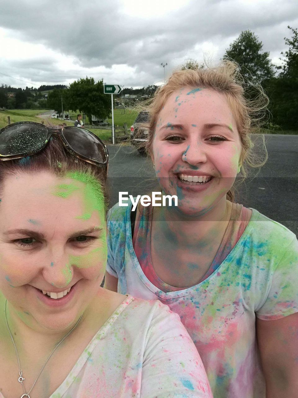 Portrait of female friends celebrating color festival