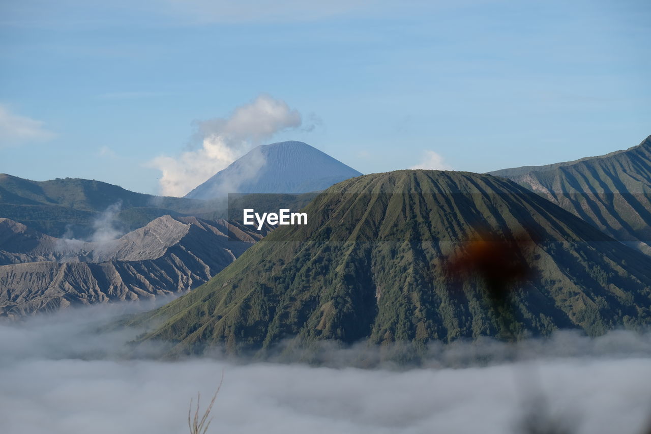 Amazing scene at bromo, indonesia with smoky volcano and dancing clouds.