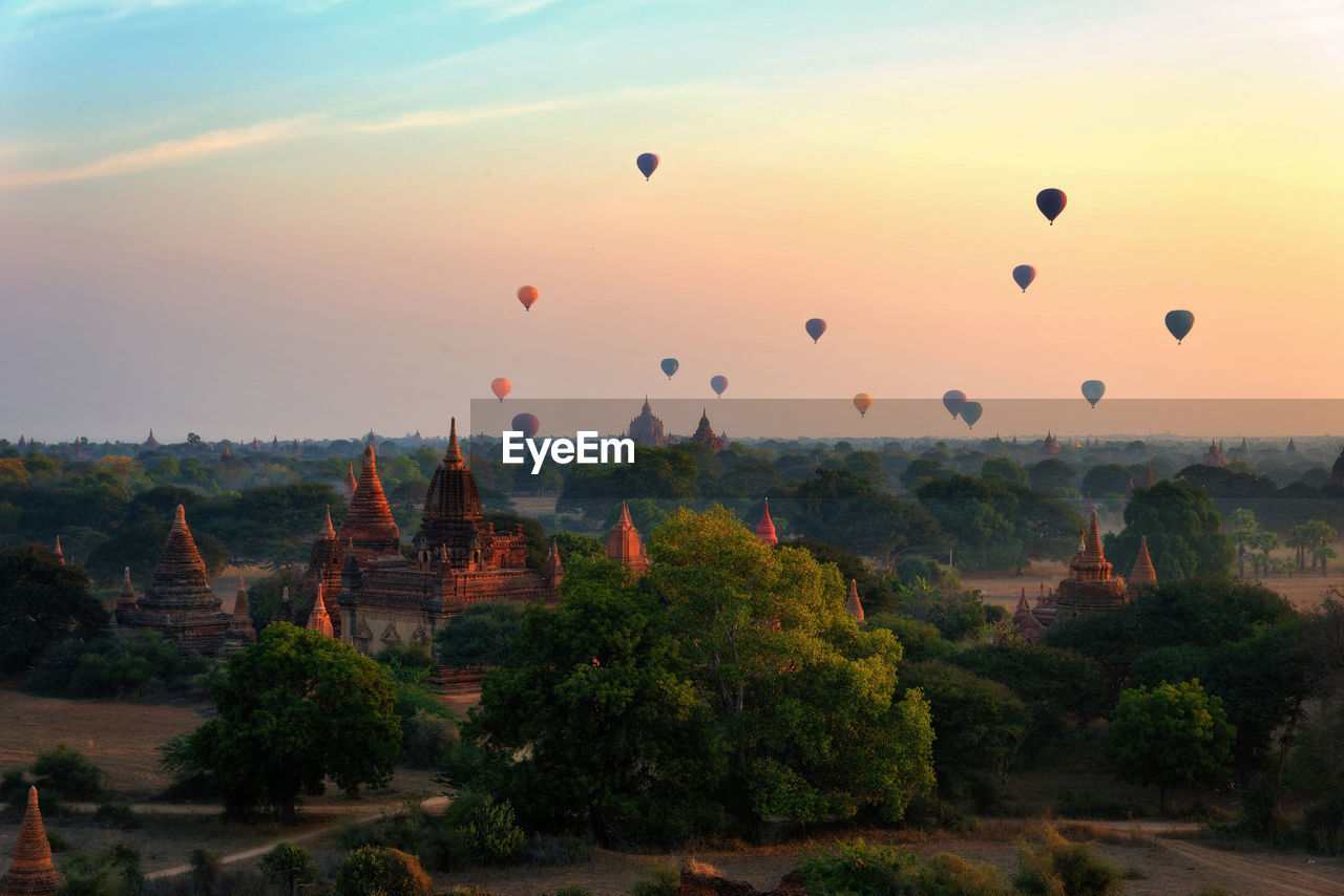 Hot air balloons against sky at sunset