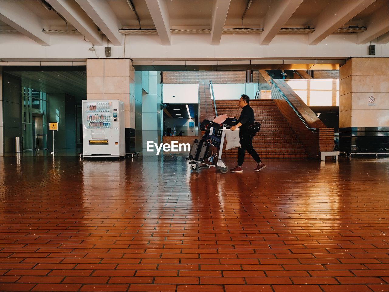 PEOPLE WALKING IN BUILDING CORRIDOR