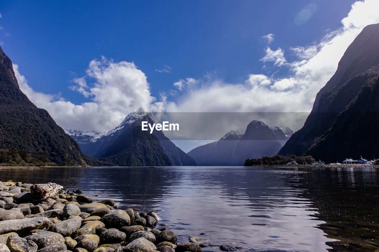 Panoramic view of lake by mountains against sky