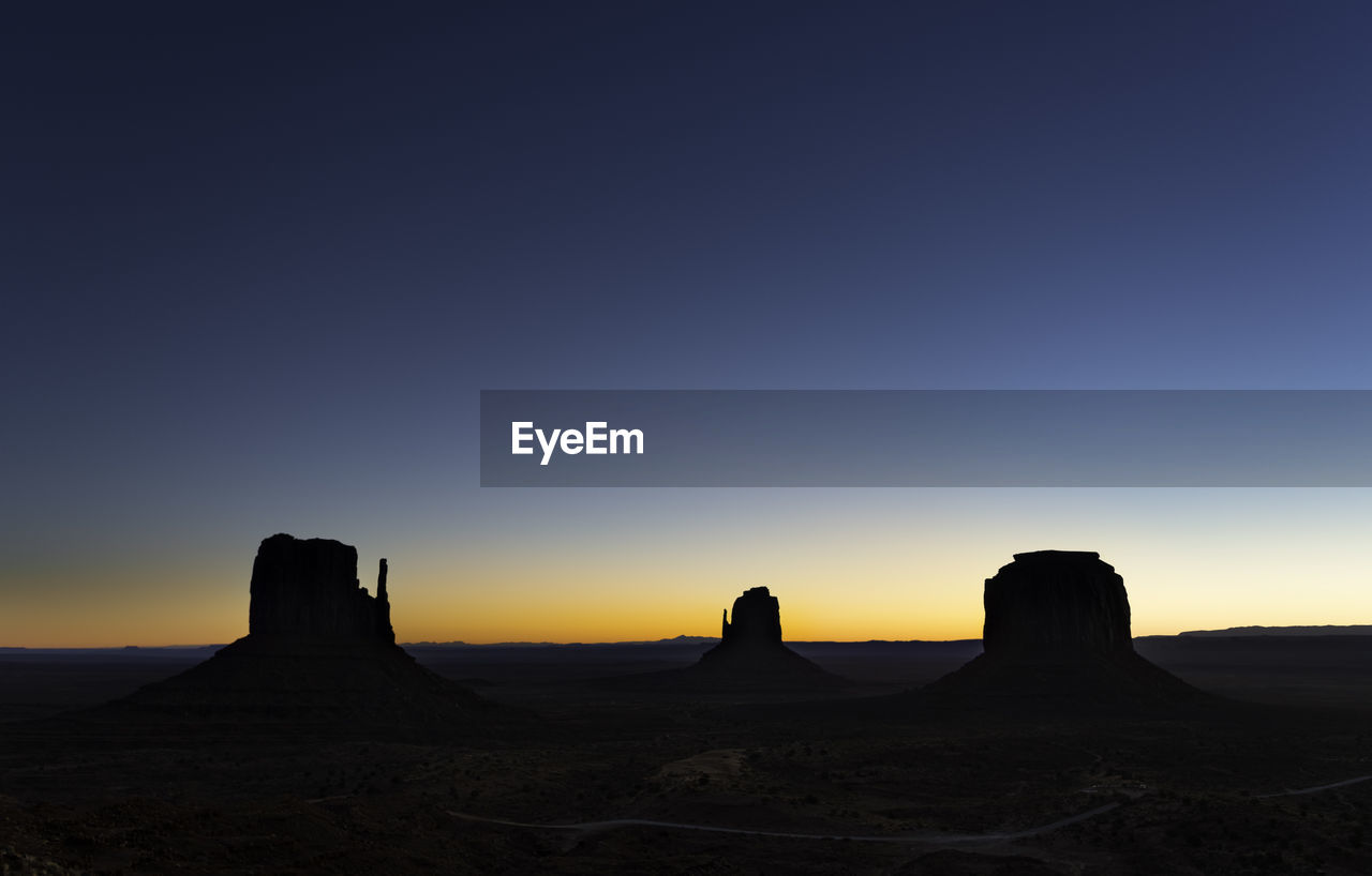 Scenic view of silhouette landscape against clear sky during sunset