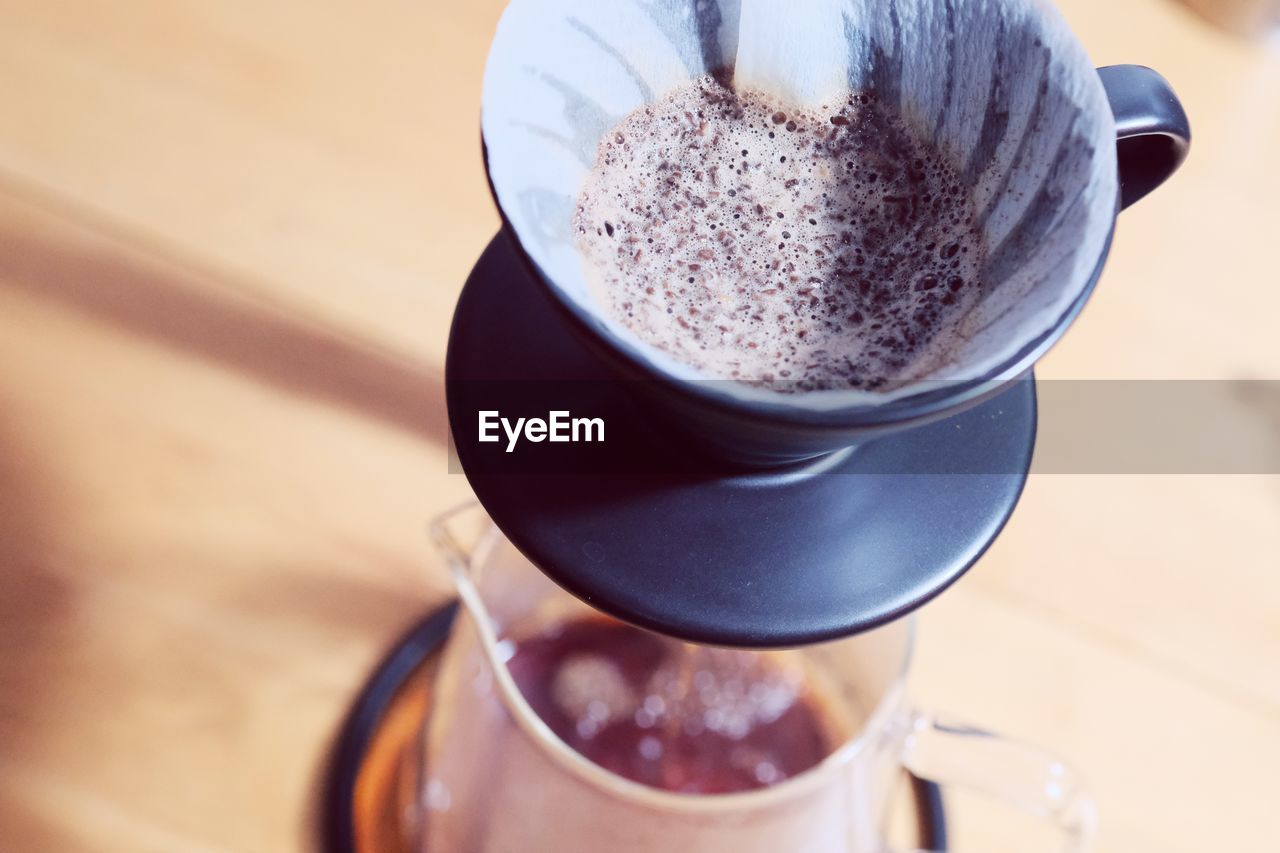 Make drip coffee ,barista pouring water on coffee ground with filter