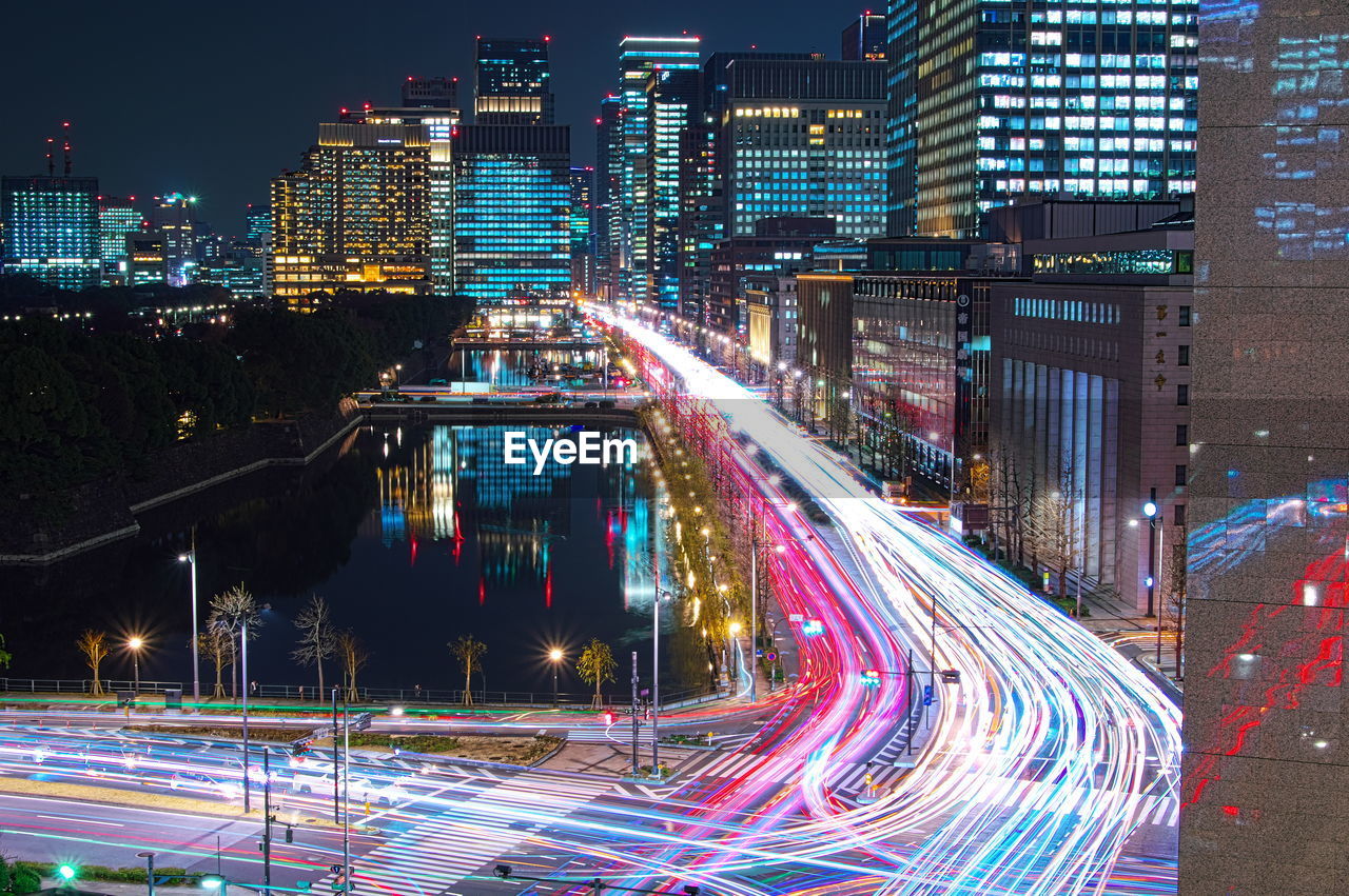 High angle view of illuminated city street and buildings at night