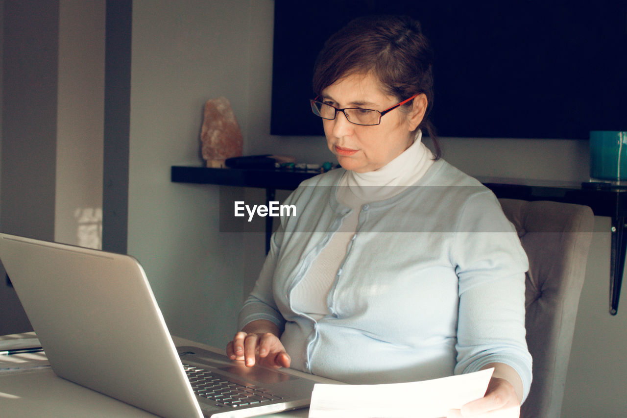 Woman using laptop at table