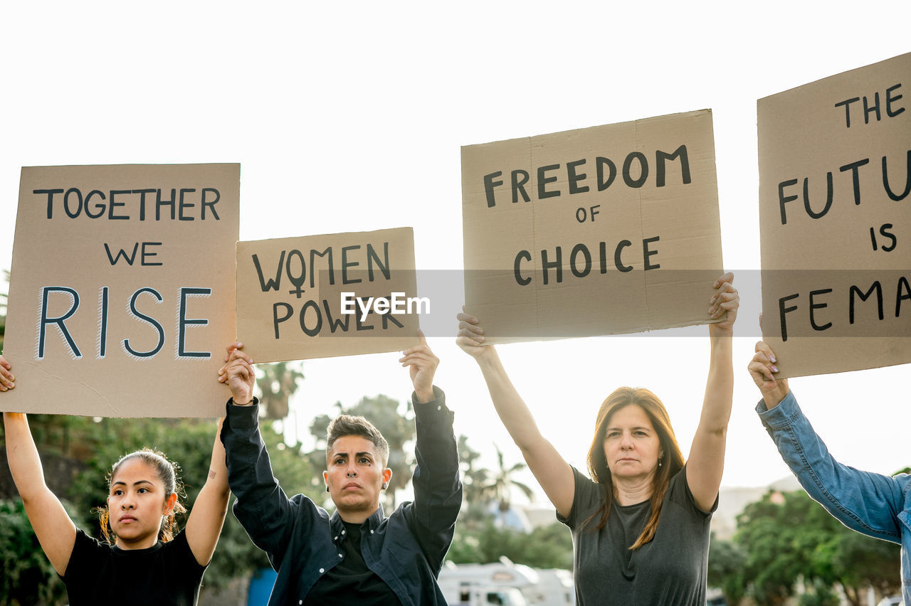 Happy protesters with placards on street