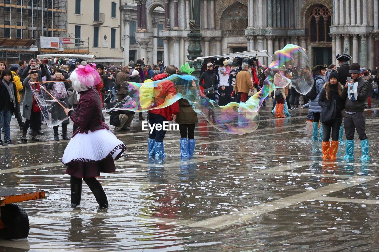 Woman performing with bubble wand at san marco