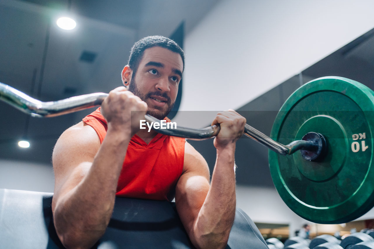 Portrait of man exercising in gym