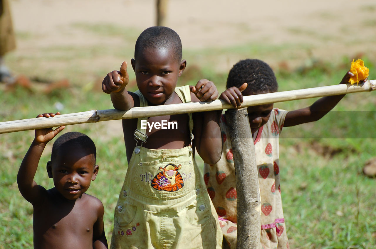 PORTRAIT OF BOYS PLAYING WITH CHILDREN