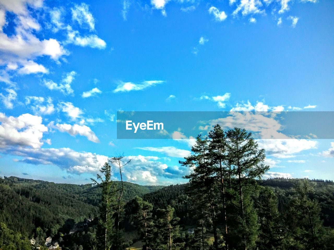 Scenic view of mountains against cloudy sky