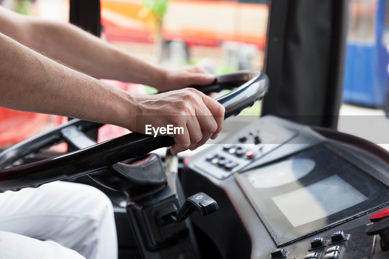 Midsection of man driving bus