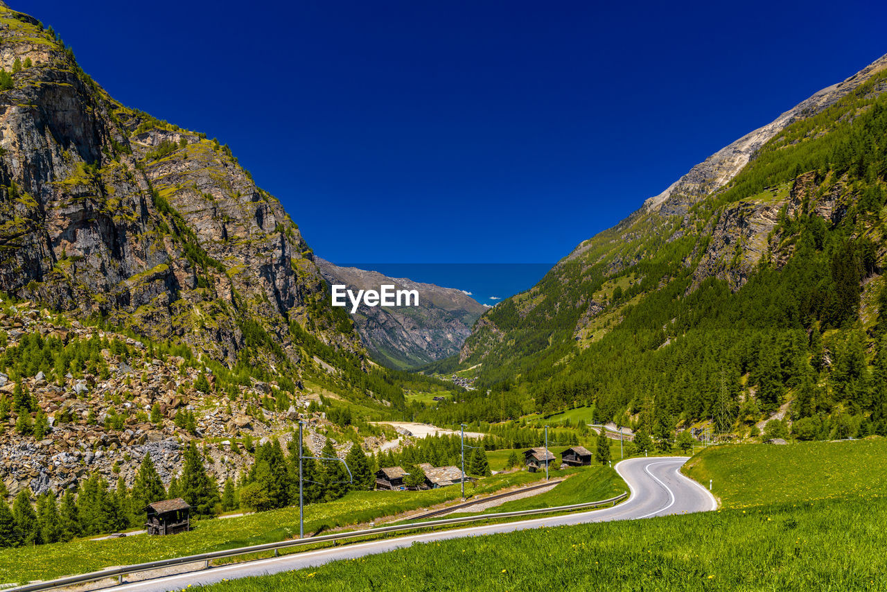 Scenic view of mountains against clear blue sky