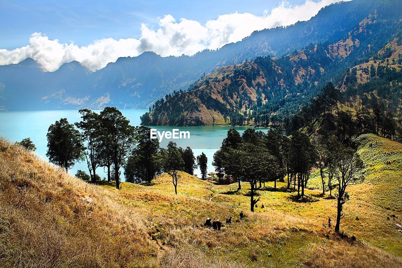 Scenic view of field and mountains against sky