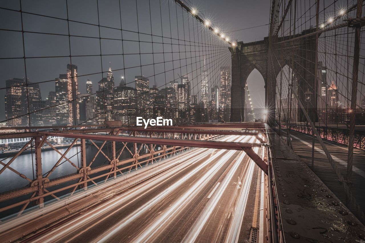 Light trails on bridge in city at night