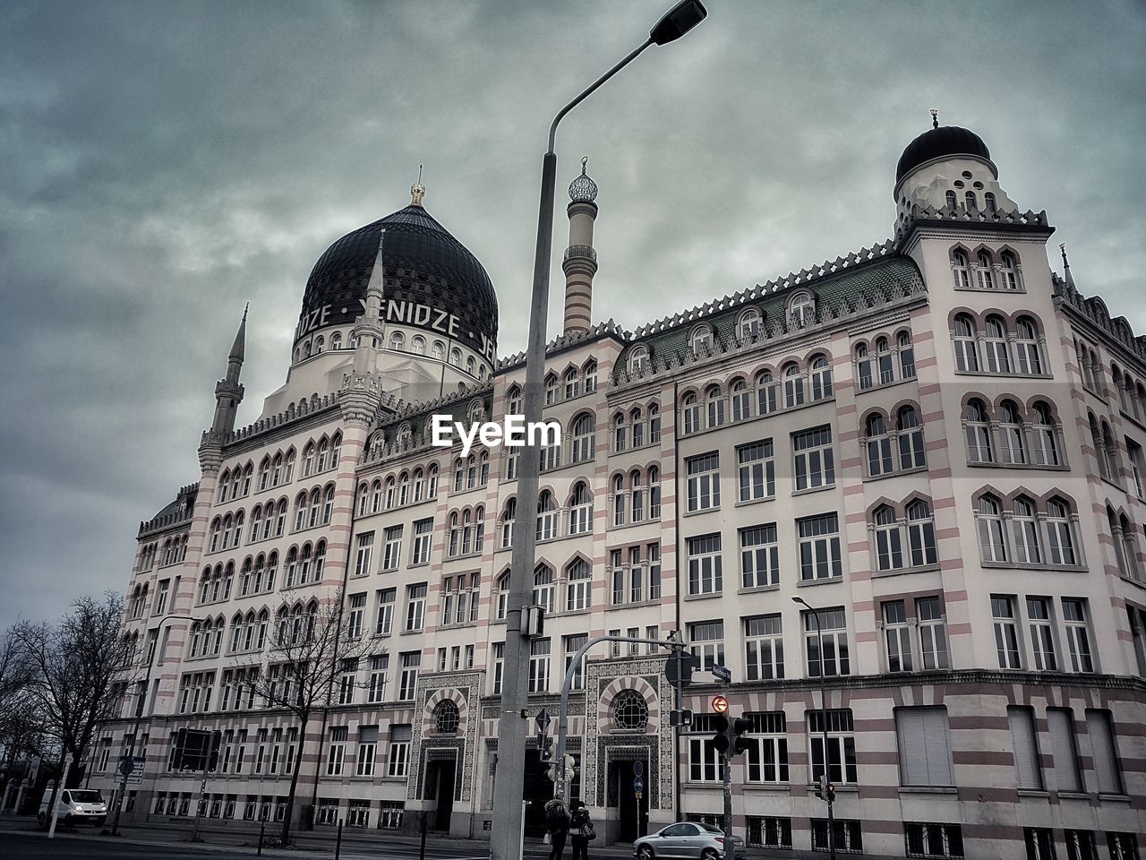 Low angle view of buildings against cloudy sky / yenidze dresden 