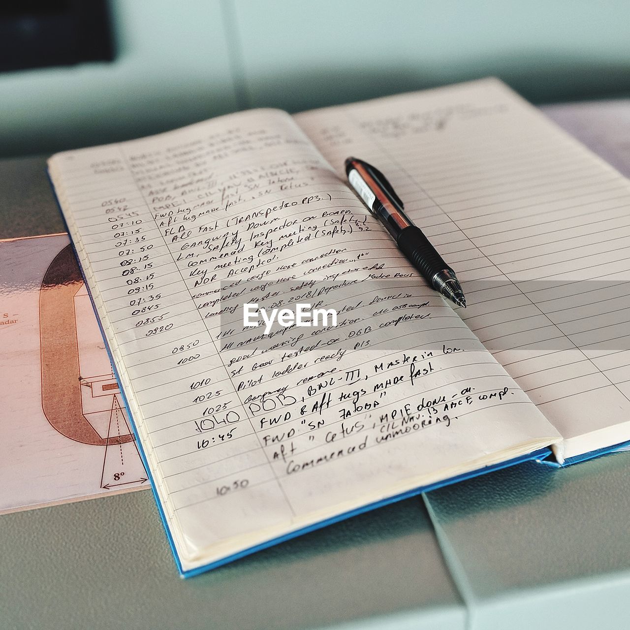 HIGH ANGLE VIEW OF BOOK ON TABLE