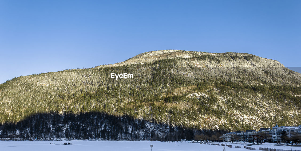 Scenic view of snowcapped mountain against clear blue sky