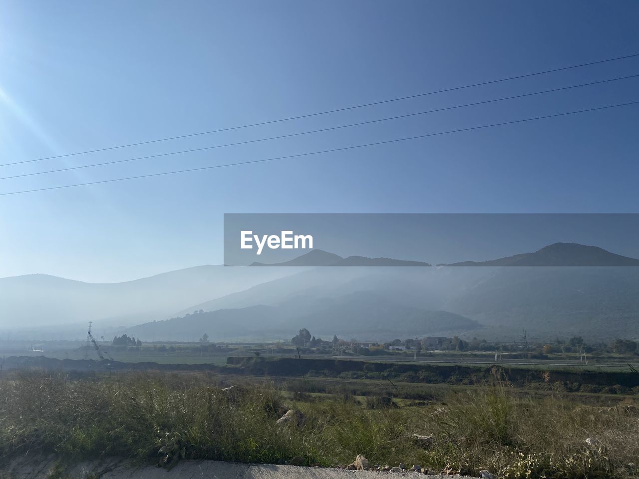 SCENIC VIEW OF FIELD AND MOUNTAINS AGAINST CLEAR SKY