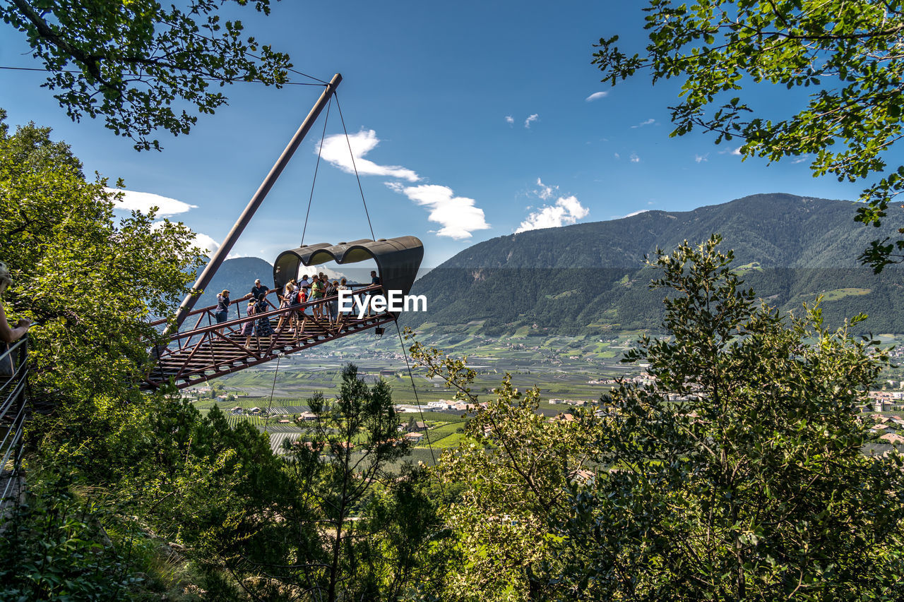 tree, plant, nature, sky, mountain, beauty in nature, travel, architecture, scenics - nature, environment, mountain range, day, travel destinations, outdoors, land, no people, landscape, cloud, tourism, transportation, built structure, sunlight, water, park, blue, growth