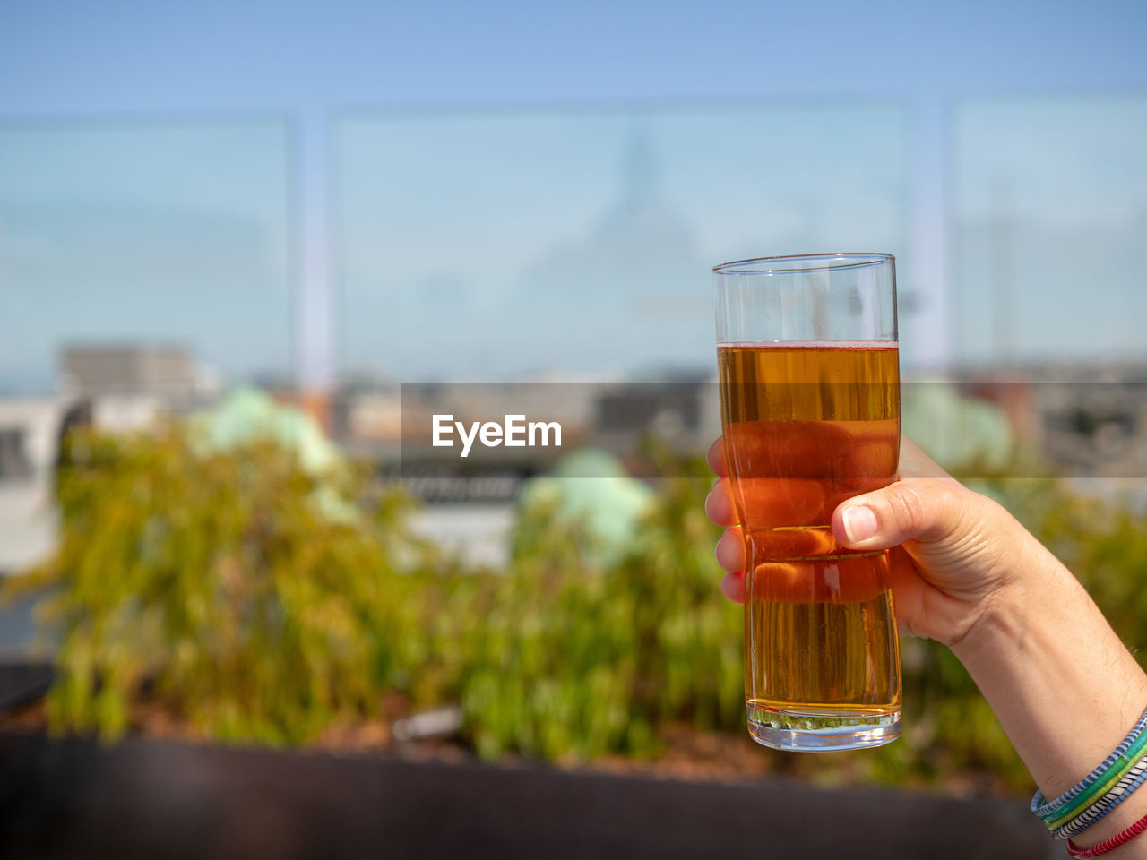 HAND HOLDING GLASS OF BEER