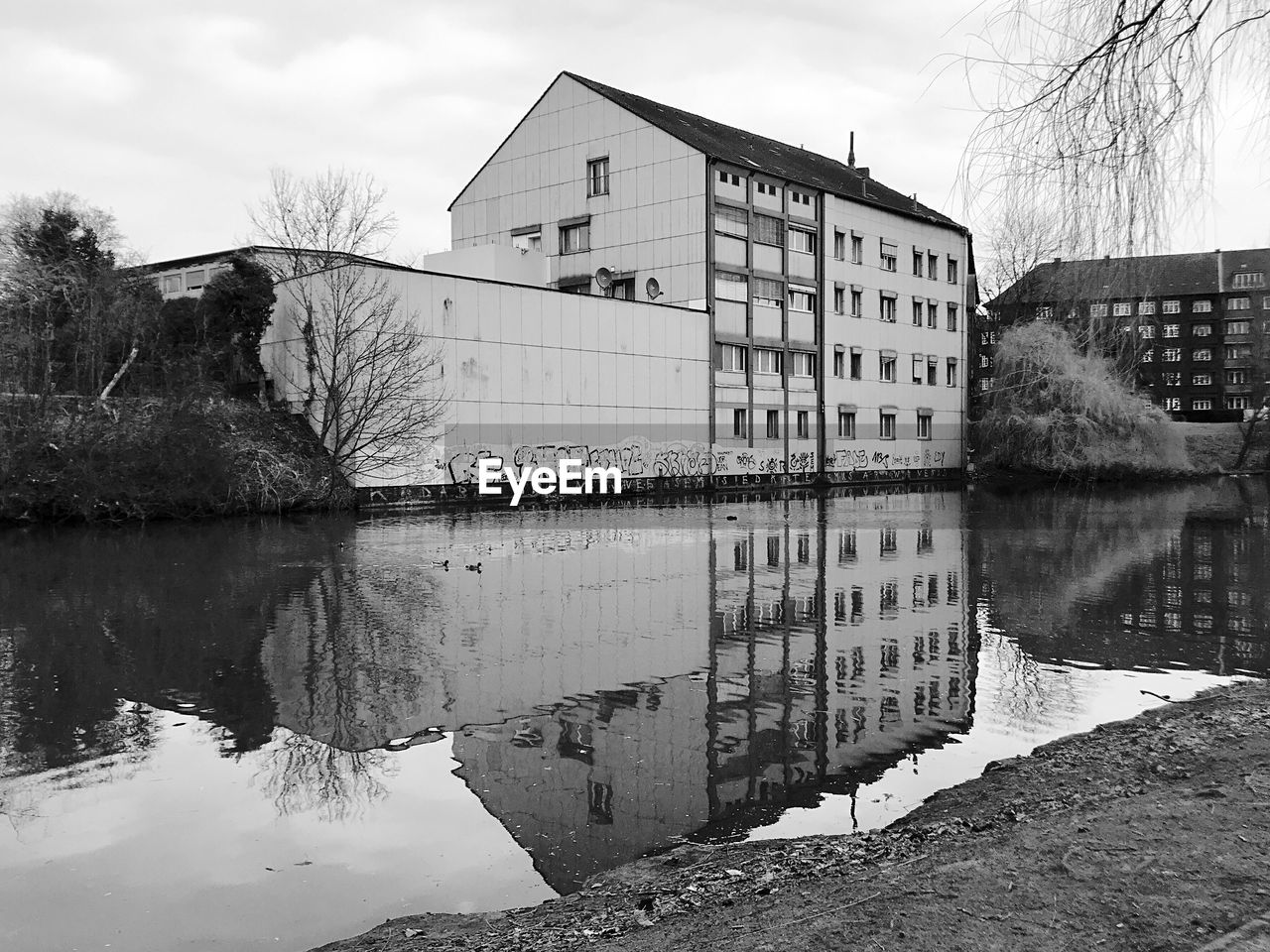 Reflection of building on lake against sky