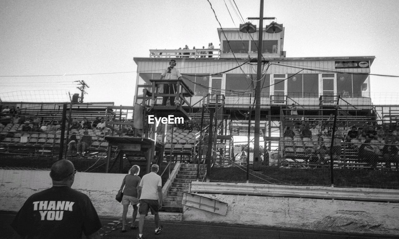 WOMAN STANDING ON BUILDING TERRACE