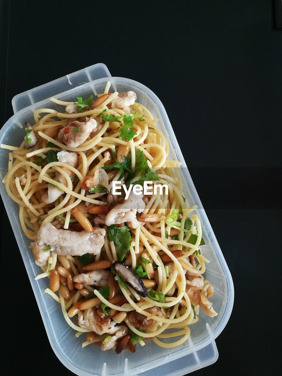 High angle view of meal served in plastic container against black background