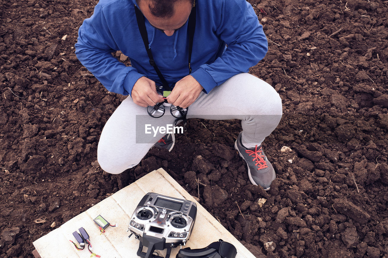 Young man prepares the drone for flight