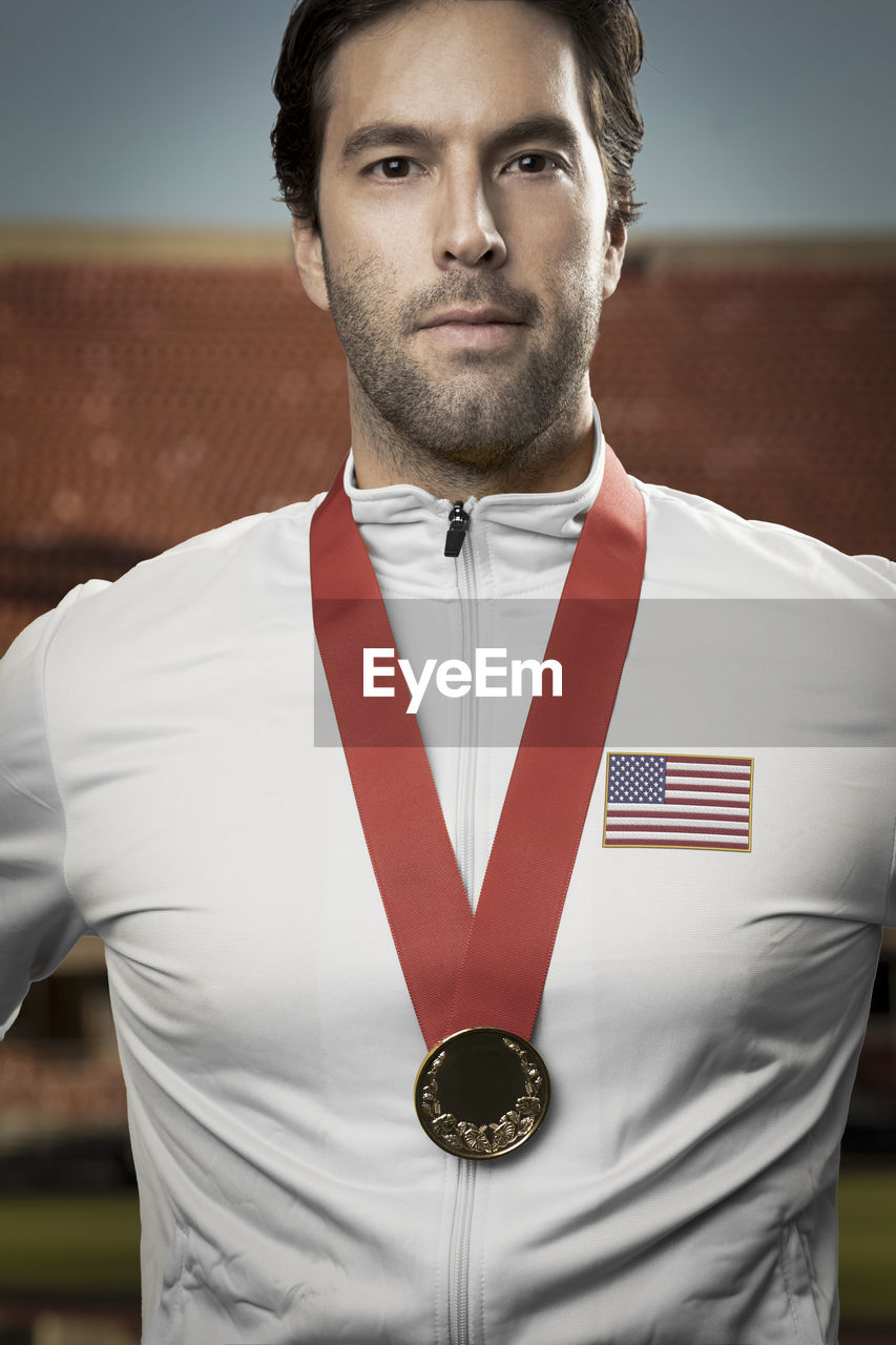 American athlete receiving a medal in a stadium