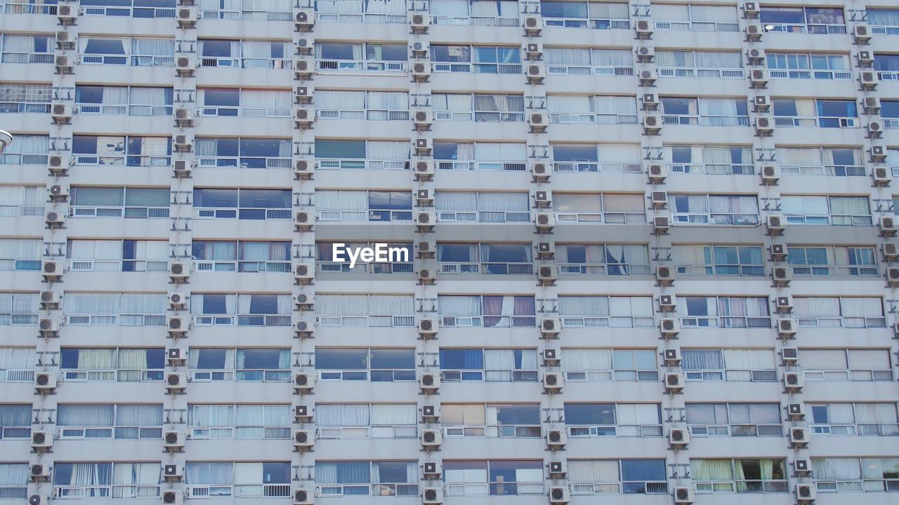 Low angle view building with windows and air conditioners