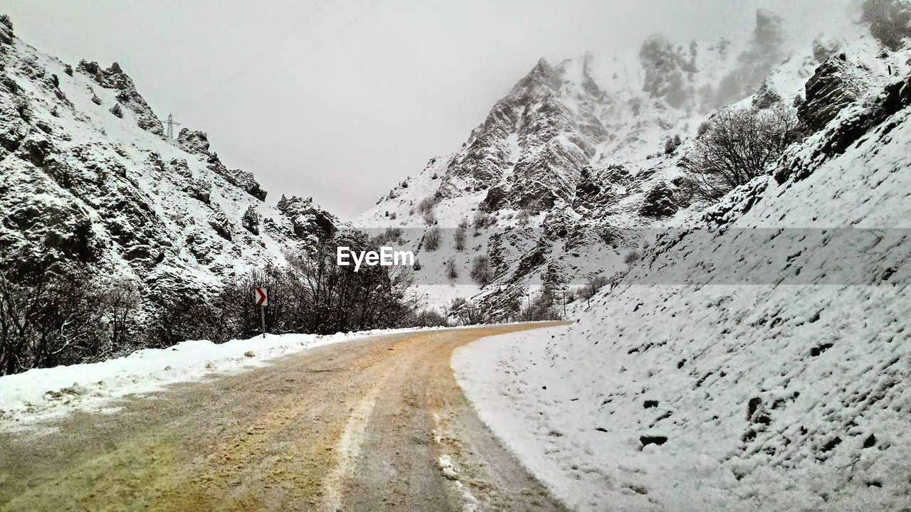 Road passing through snow covered mountains