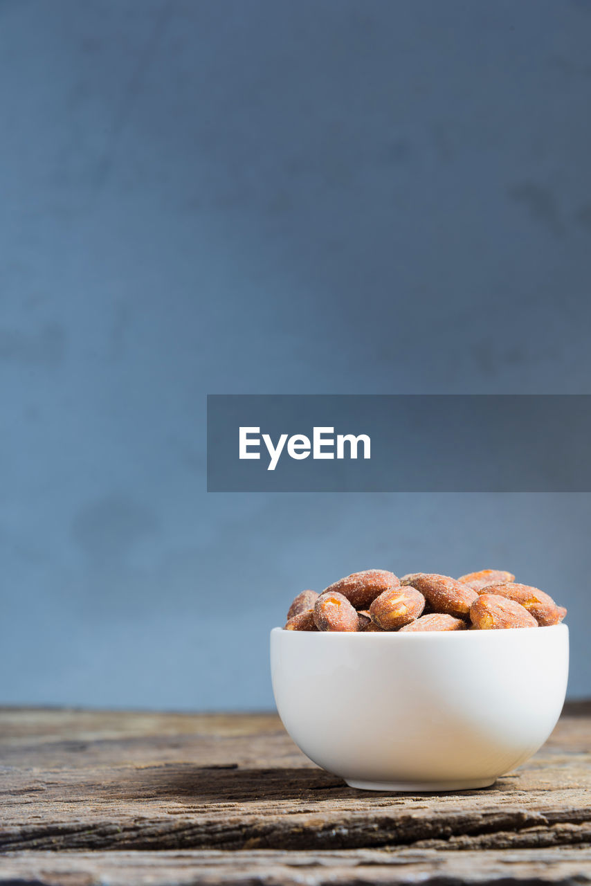 Close-up of salted almonds in bowl on table