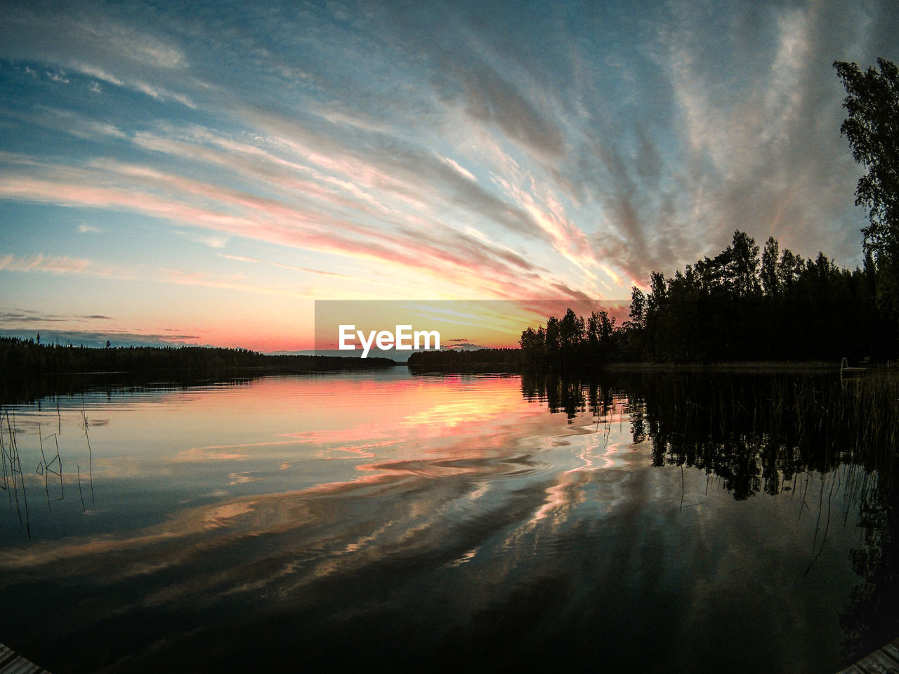 Scenic view of lake against sky during sunset