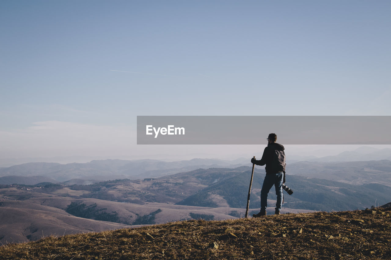 Man standing on mountain road