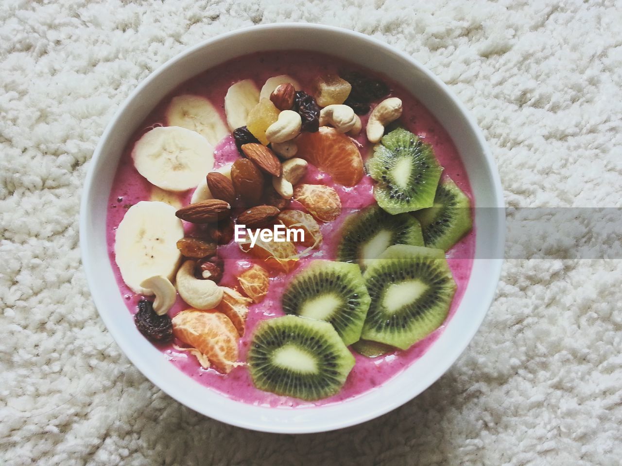 Directly above shot of fruits in bowl on rug